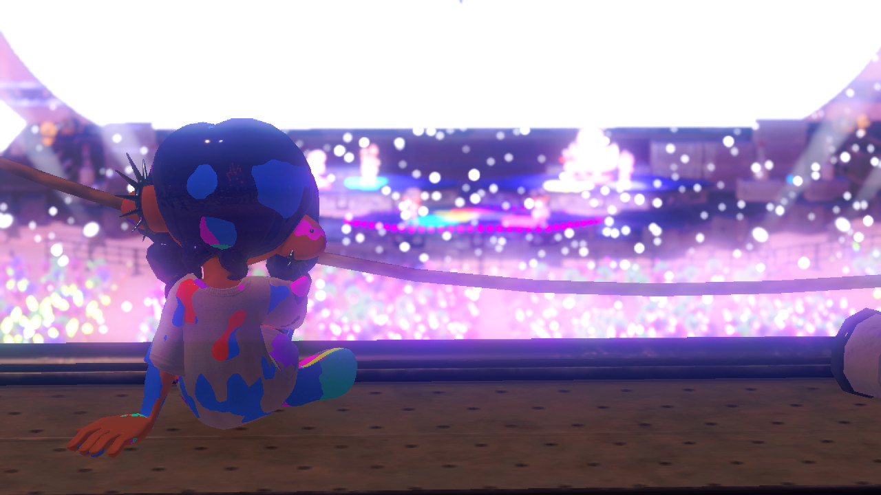 my inksona at the viewing booth looking at the concert stage with glitter falling